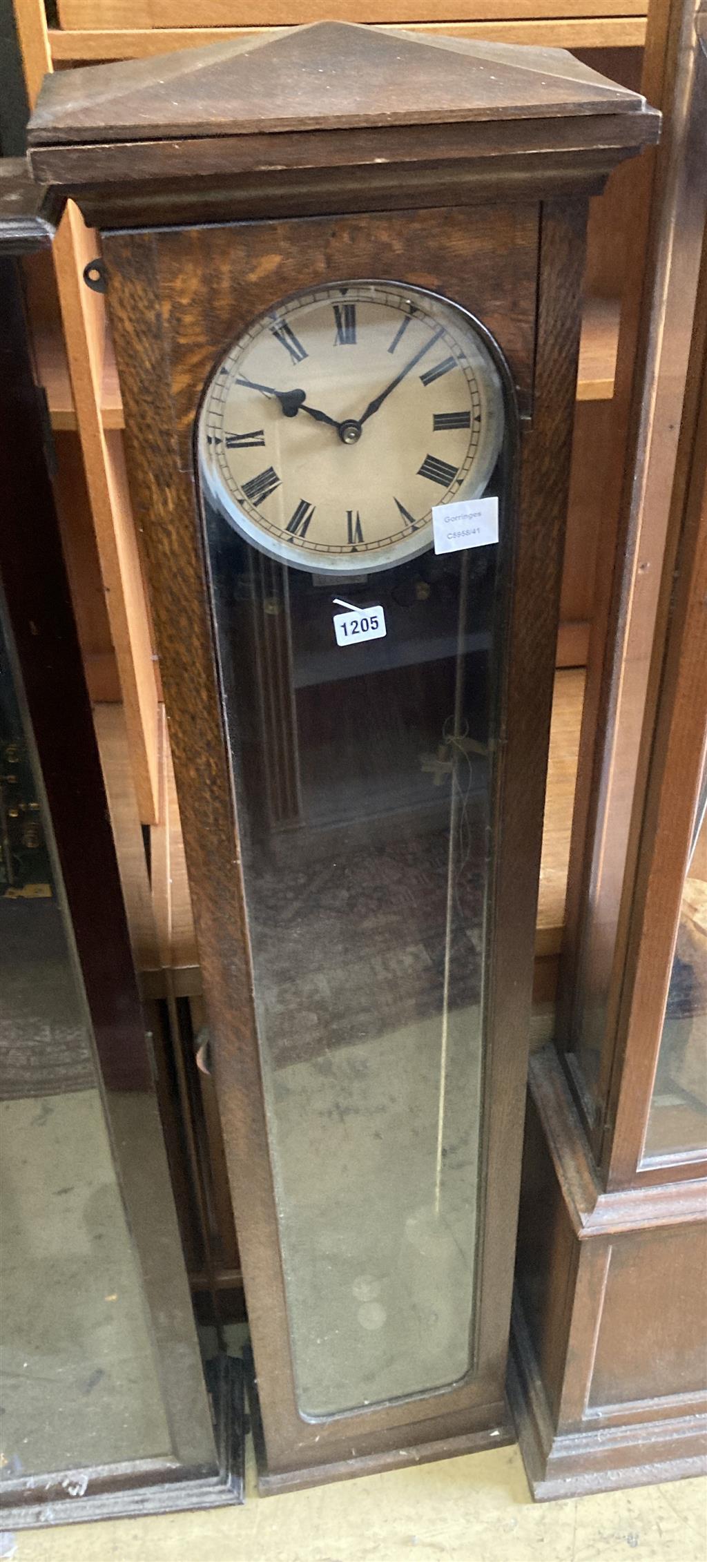 An early 20th century oak cased electric pendulum clock